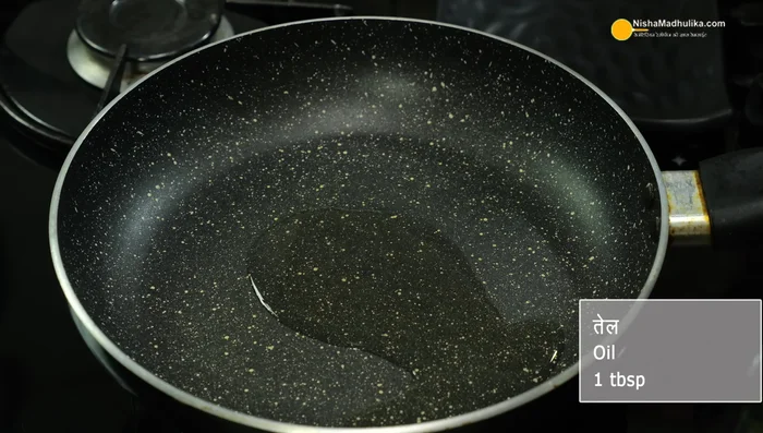 Prepare the potato stuffing: Heat oil in a pan, add mustard seeds, cumin seeds, grated ginger, and chopped green chilies. Fry until fragrant.