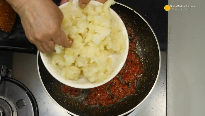 Add boiled and mashed potatoes (400g) to the pan. Mix well and cook until heated through. Add asafoetida for extra flavor.