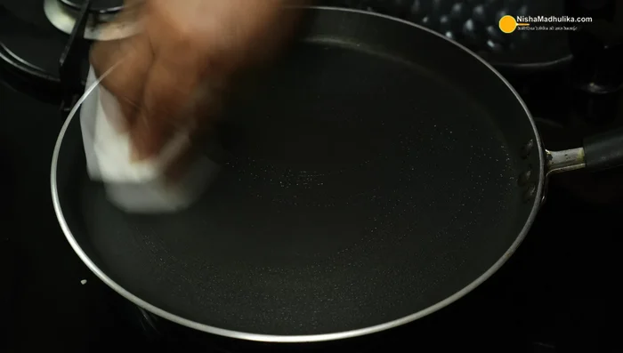 Heat a non-stick pan and apply oil. Pour 2 spoons of batter onto the hot pan and spread thinly in a circular motion.