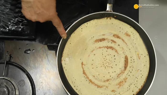 Cook the dosa until golden brown, then add the potato stuffing. Fold and serve with chutney.