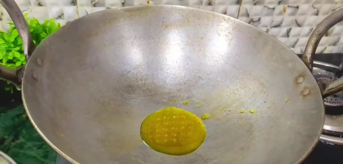 Once the oil is hot, add half a teaspoon of cumin seeds and let them crackle.