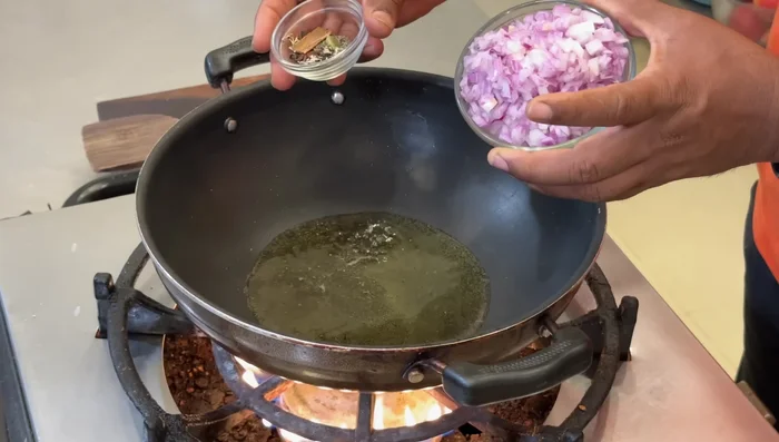 Heat oil in a pan. Add whole garam masala and sauté. Add chopped onions and fry until golden brown.