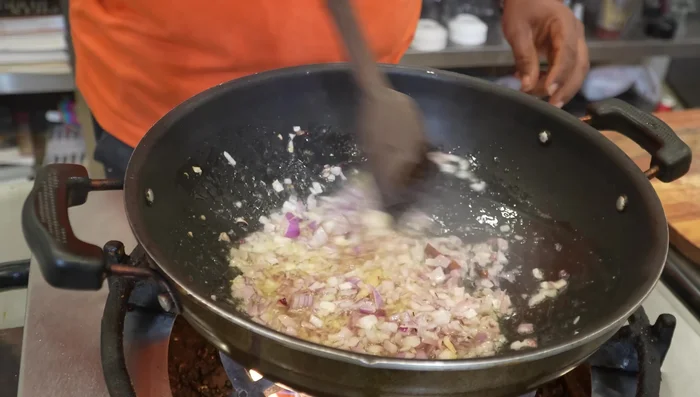 Add the paste to the pan. Add turmeric and bay leaf, and optionally mint.