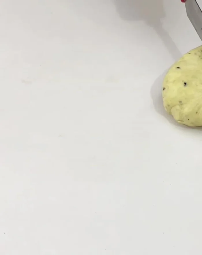 Roll the dough: Divide the rested dough into two pieces. Roll each piece into a very thin sheet, thinner than a samosa wrapper.