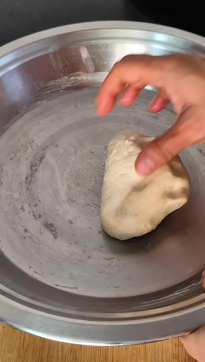 Knead the dough again. If it's too soft, add 1-2 tablespoons of flour and knead until smooth.