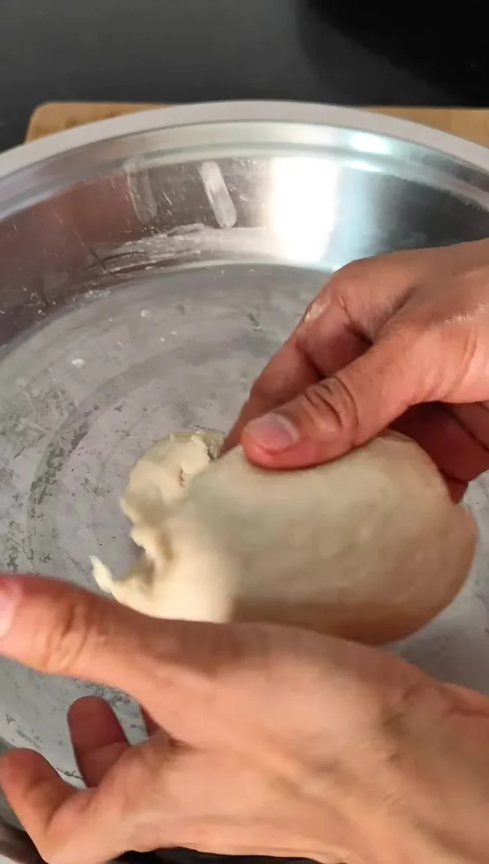 Shape the samosas: Make small dough balls, roll them into circles (slightly smaller than roti size and not too thick). Place stuffing in the center, fold into triangles, sealing the edges with water.