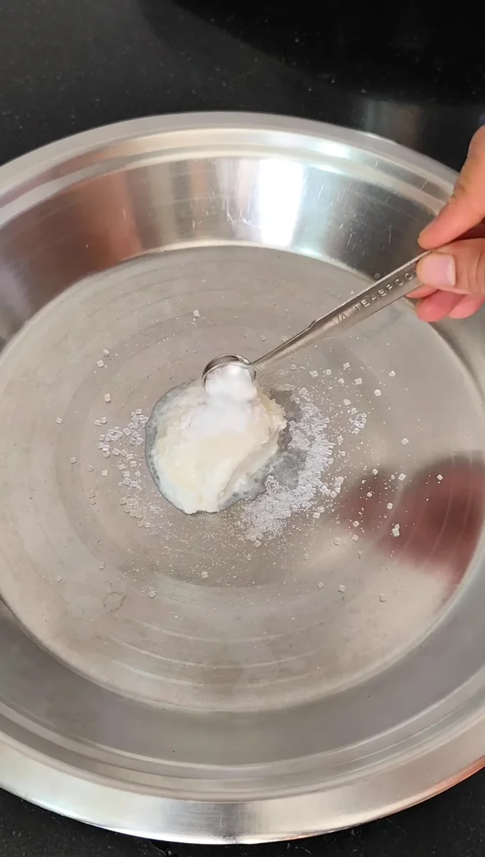 Prepare the dough: In a plate, mix curd, sugar, salt, and baking soda. Mix well 2-3 times until sugar dissolves and soda activates.