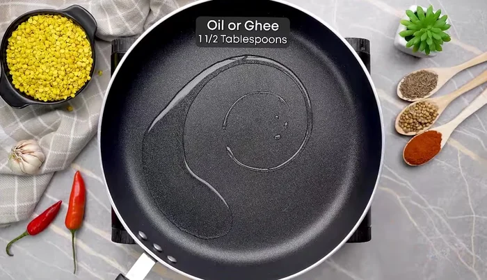 Heat ghee (or oil) in a pan. Add cumin seeds and hing, cook for a few seconds.