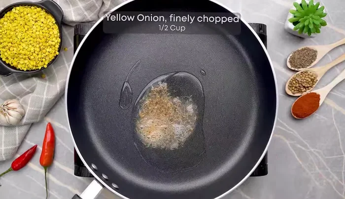 Add diced onions and cook until soft and light golden. Add crushed ginger, garlic, and green chili; sauté for a minute.