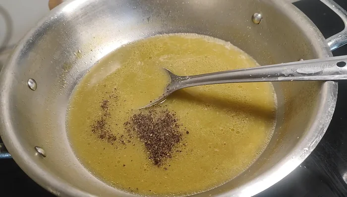 Season with salt, black pepper, and chili powder to taste.