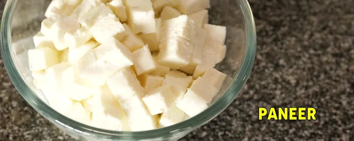 Add paneer (or chicken/tofu). Remove any foam that forms during boiling.