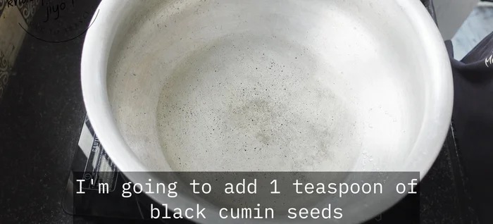 Heat 4 tbsp of oil in a pan. Add 1 tsp black cumin seeds, 1 tbsp black peppercorns, 1 marble-sized stone flour, 1 bay leaf, 1 cinnamon stick, 4 cloves, and 3 green cardamoms. Fry until spices crackle.