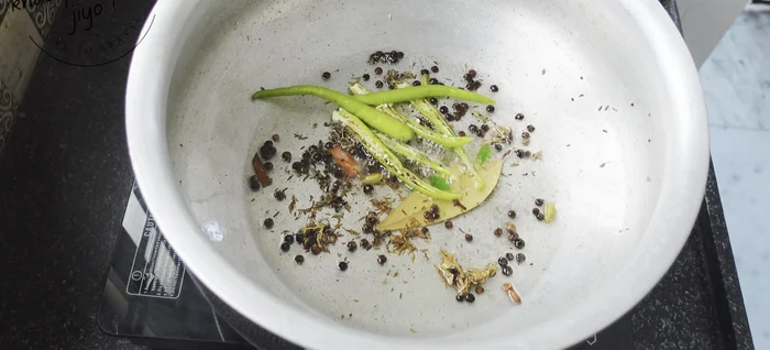 Add 3 slit green chilies and a handful of curry leaves. Stir-fry for 1-2 minutes.