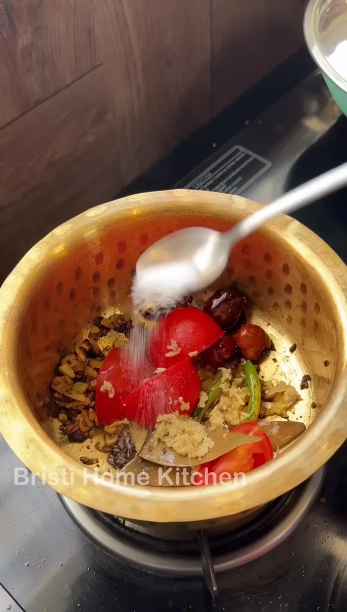 Add chopped tomatoes, ginger, red chilli powder, and turmeric powder. Sauté (333.08).