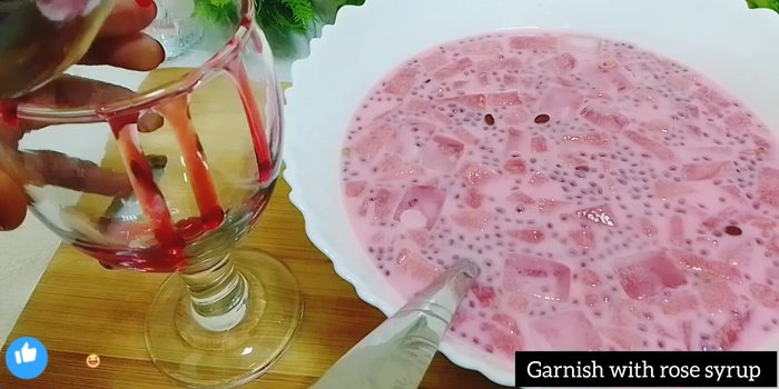 Serve in a glass, garnished with rose syrup and watermelon pieces.