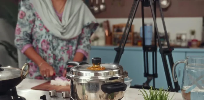 While the beans boil, finely chop the onions and grind the tomatoes into a paste.