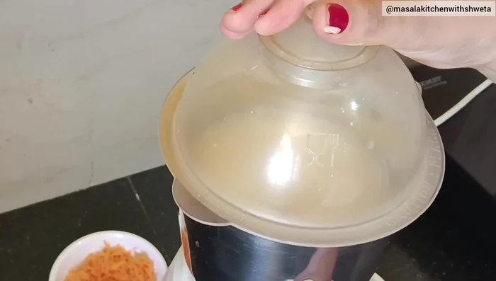 Add chopped garlic and ginger to the mixer. Grind until coarse, then add about 25ml of water to get a smooth batter.