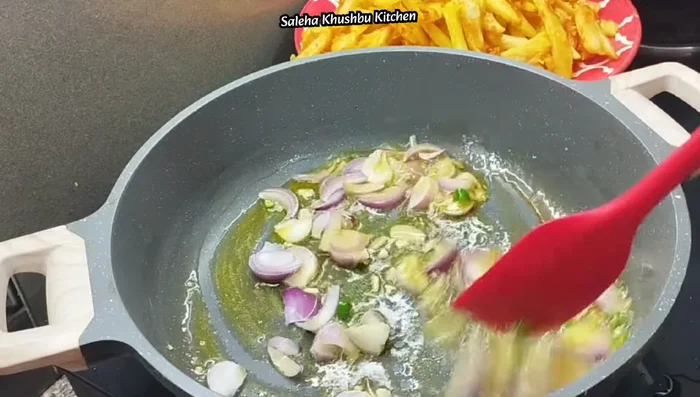 Add sliced onions and capsicum. Sauté until slightly softened, maintaining their crunch.