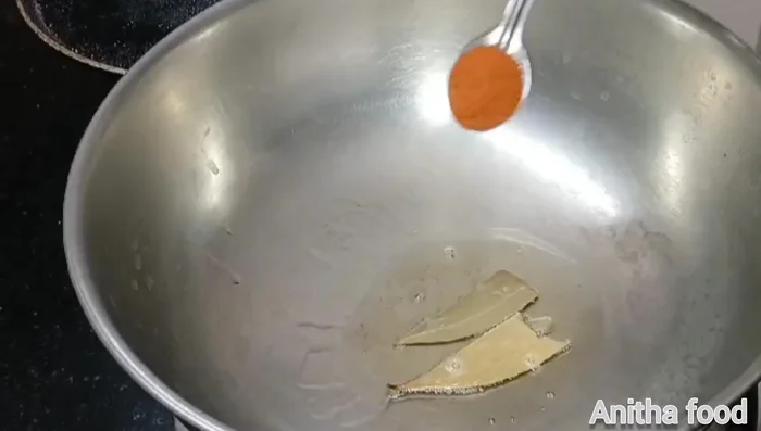 Heat oil, add bay leaves, then add chili powder (be careful not to burn it).