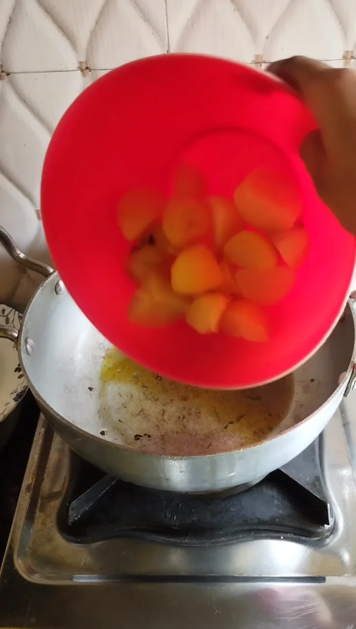 Fry the potatoes: Cut boiled potatoes into two pieces and fry until they turn red.