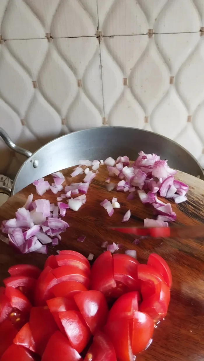 Sauté onions and tomatoes: Heat oil, add cumin seeds, then add chopped onions and fry until golden brown. Add chopped tomatoes and fry until softened.