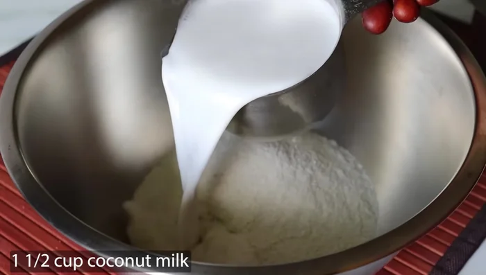 In a mixing bowl, combine the aval powder with 1 cup of coconut milk, mixing well. Then add the remaining 1/2 cup of coconut milk and mix again until a slightly thicker-than-usual idli batter consistency is achieved.