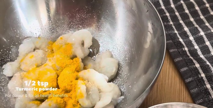 Wash, devein, and clean 250g of prawns. Marinate with salt and ½ tsp turmeric powder for 10-15 minutes.