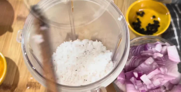 Grind the following ingredients into a smooth paste: grated coconut, garlic flakes, coriander seeds, tamarind, Kashmiri chilies, small green chilies, and water.