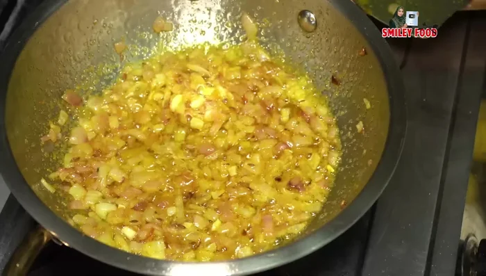 Add Kashmiri red chili powder for color and fry gently.