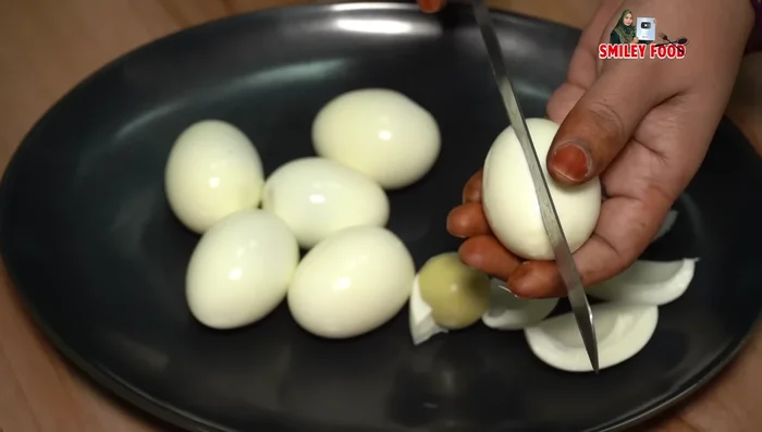 Peel the boiled eggs and carefully cut them in half lengthwise. Separate the yolks from the whites and set aside.