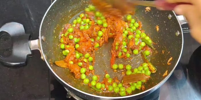 Add green peas and mix well. Keep the flame on medium throughout the cooking process.