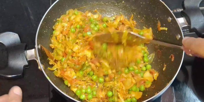 Once the cabbage is cooked and the water has dried, add less than half a teaspoon of garam masala powder. Mix well and cook for another 1-1.5 minutes.
