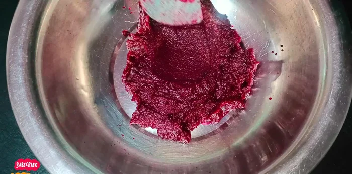 Prepare the batter: Mix semolina, gram flour (if using), curd, beetroot paste, oil, sugar, green chilies, ginger, and salt. Add water gradually to achieve a smooth, pourable batter. (167.44)