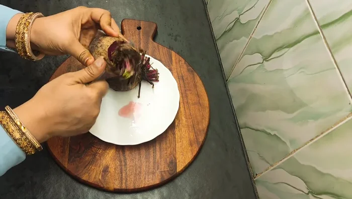 Wash and peel the beetroots thoroughly. Then, cut them into thick slices (about 1/2 inch thick).