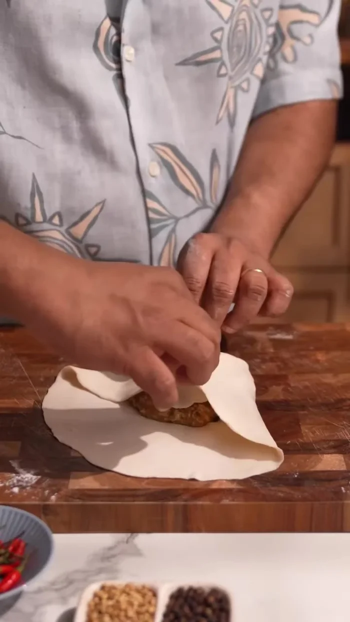 Place the mincemeat mixture in the center of the paratha. Fold all sides and seal with a little water.