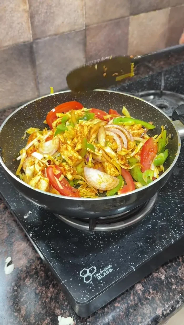 Add the cut vegetables to the pan with the paneer, and mix well. Season with salt, garam masala, and red chili powder to taste.