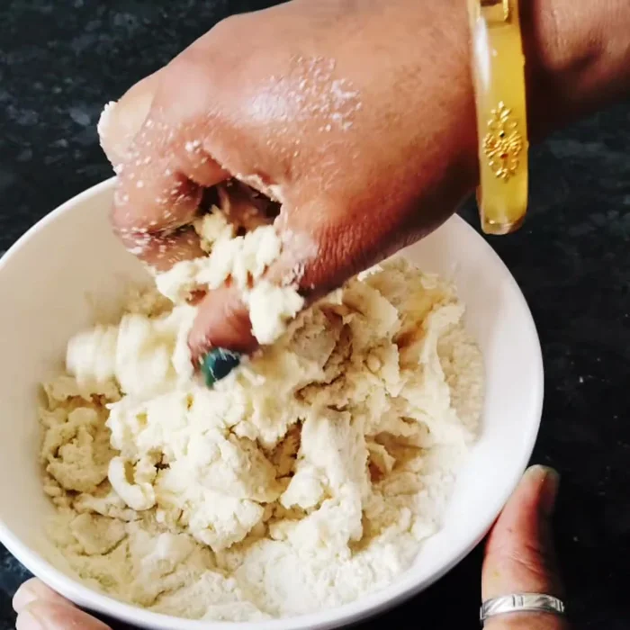 Add curd and water to make buttermilk. Gradually add buttermilk to the dry ingredients, mixing until a soft dough forms.