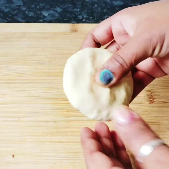 Divide the dough into small balls. Roll each ball into an oval shape.