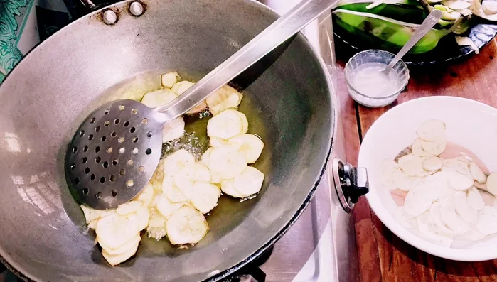 Remove the fried chips using a strainer to drain excess oil.