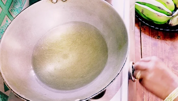 Heat oil in a pan on the gas stove.