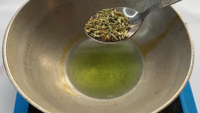 Temper the oil with panch phoron and a dried red chili.
