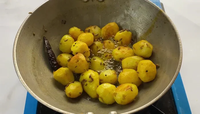 Add a little water to the potatoes, cover, and steam for 2 minutes to cook the potatoes through.