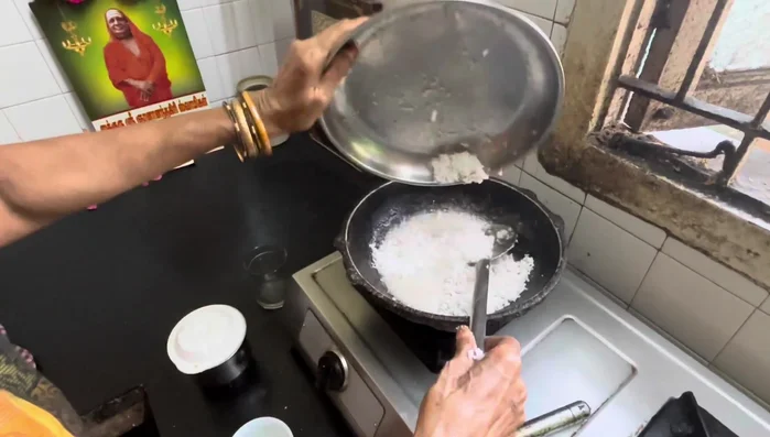 Add the finely grated coconut to the sugar syrup.