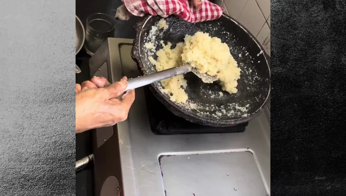Grease a plate with ghee (clarified butter). Transfer the coconut mixture to the greased plate.
