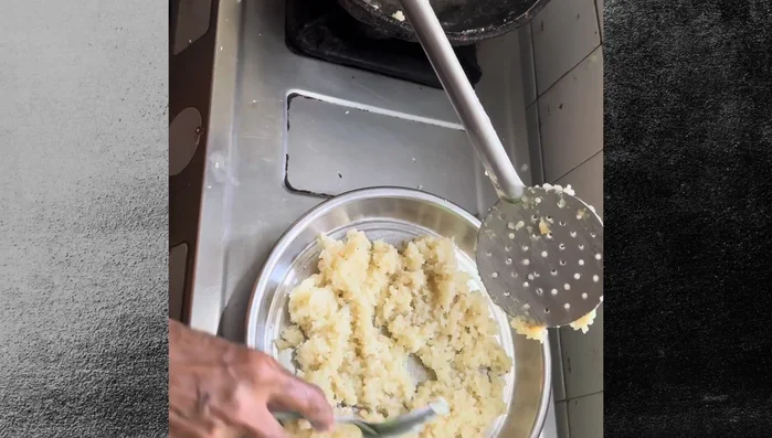 Spread the mixture evenly. Smear ghee on a ladle and crack it over the mixture (an important step).