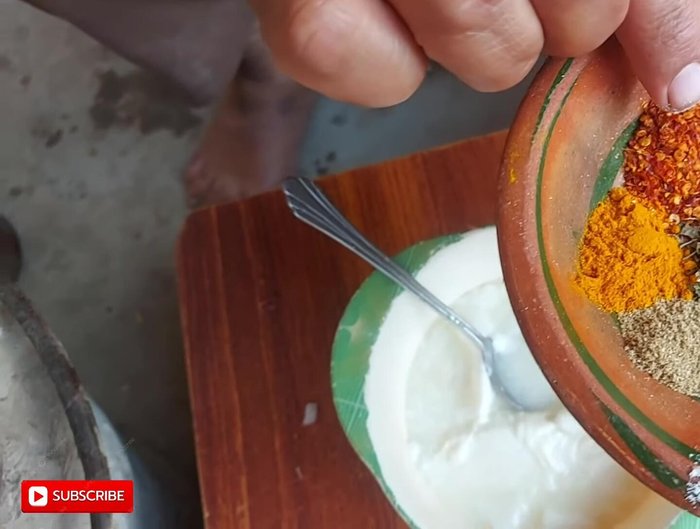 Mix all spices (salt, Jada chilli powder, turmeric, coriander powder, garam masala, grated cow masala, fenugreek) into the yogurt.