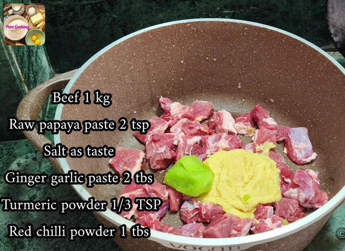 In a large vessel, add 1 kg of meat, 2 tablespoons of ginger-garlic paste, 2 tsp of raw papaya paste, salt to taste, 1/3 tsp turmeric powder, 2 tbsp red chili powder, 1 tsp coriander powder (optional), 1/4 tsp Hyderabadi Garam Masala, 1/4 tsp green cardamom powder, chopped coriander and mint leaves, and more than half of the fried onions.