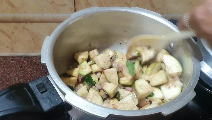 Add salt and continue to fry the brinjals until they are about 75% cooked.