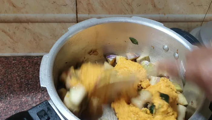 Add the ground spice paste and stir until the raw smell disappears.