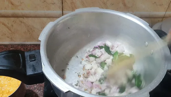 Add curry leaves and the fried onion powder. Fry until lightly browned.